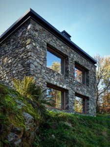 A Modern Mountain Cabin With A Rustic Stone Shell