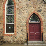 Arched or pointed doors and windows are typical of the style.